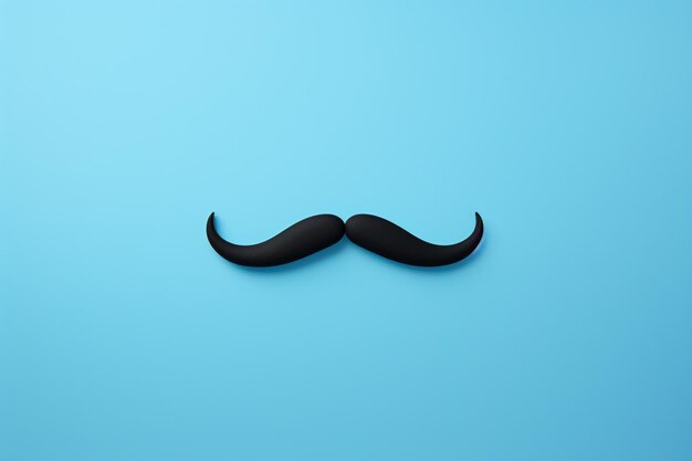 Photo a black mustache on a blue background