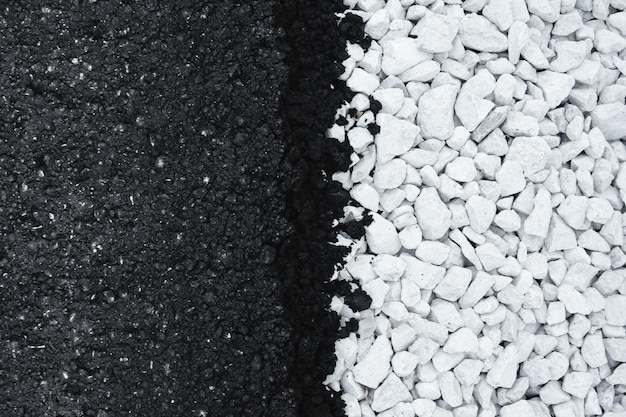 Black new asphalt and white gravel flat background.