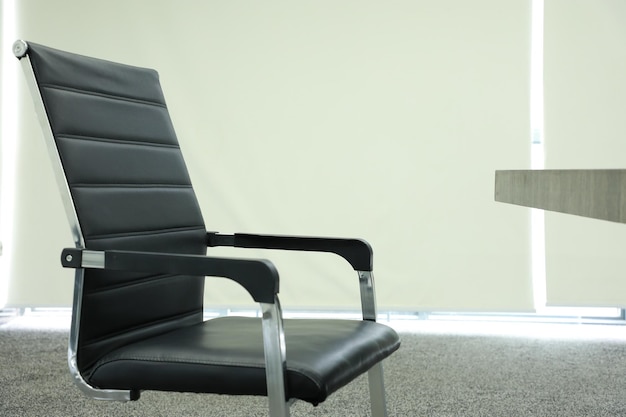 Black office chair in the lobby of a modern office building stock photo