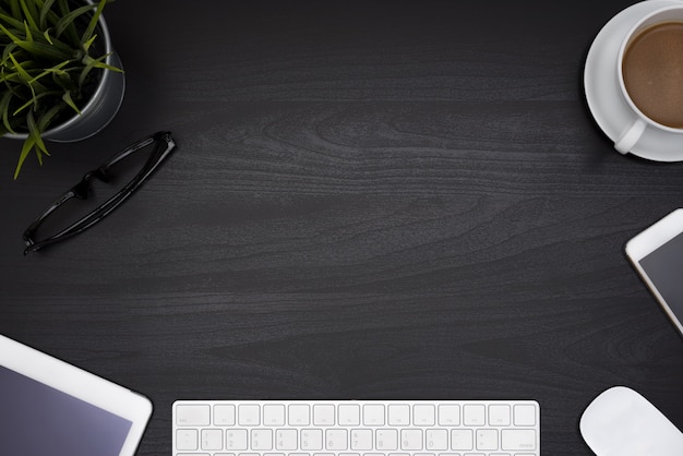 Black office desk table with computer notebook and coffee cup