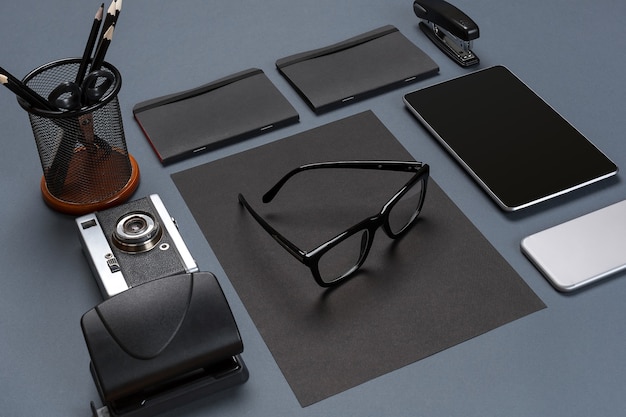 Black office stuff collection flat lay. Top view on set of stationery with smartphone and tablet. Modern life, communication, time-management, technologies concept