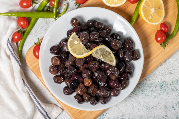 Black olive Olives on a wooden serving board Top view