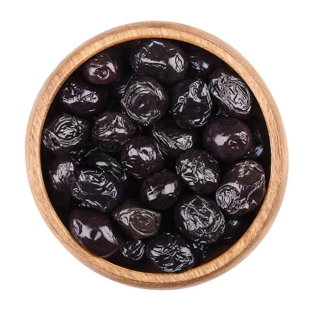 Black olives in a bowl on white