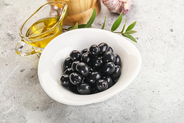 Black olives with oil and branch