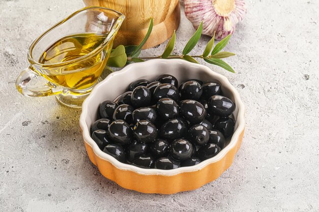 Black olives with oil and branch