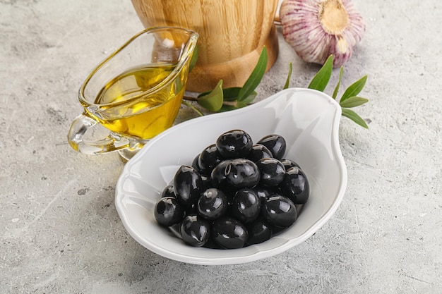 Black olives with oil and branch