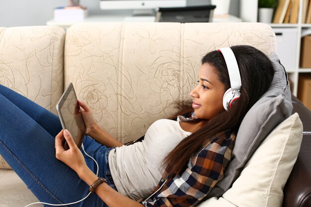 Black ordinary female american teen portrait at home sofa remote education concept.