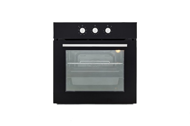 Black oven with closed door and three baking sheets front view isolate on white