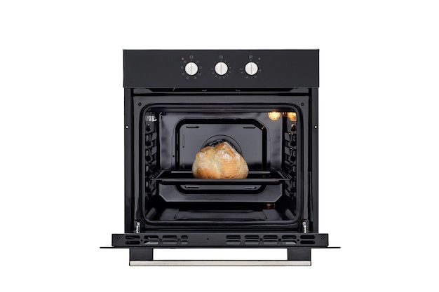 Black oven with open door and baked bread front view isolated on white