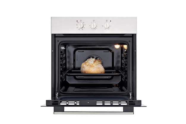 Black oven with silver control panel three round control knobs Open door and baked bread inside lights on inside Front view Isolate on white