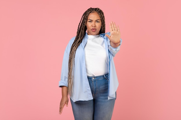 Black Oversized Female Gesturing Stop Standing On Pink Background