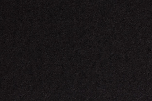 Black paper background texture. High resolution photo.