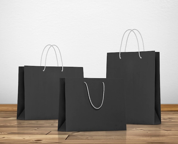 Black paper bag in room white walls and wooden floor