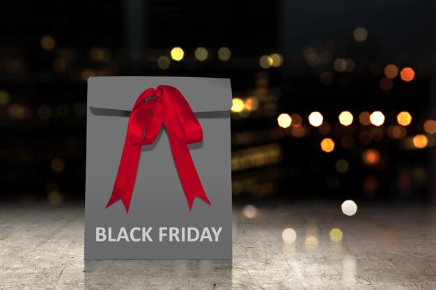 Sacchetto di carta nero con un nastro rosso con testo del black friday