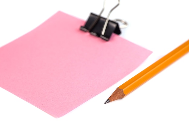 Black Paper clip and pink paper isolated on white background.