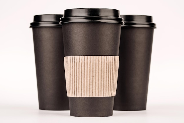 Black paper cups on white background