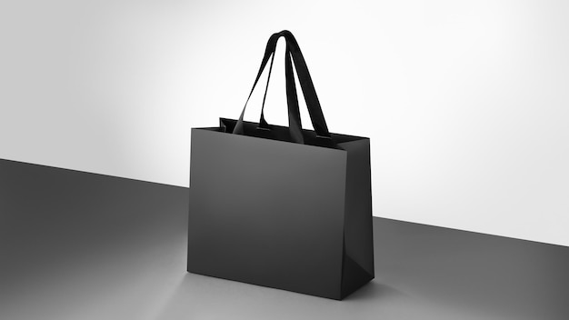 Photo black paper glossy shopping bag mockup with black handles