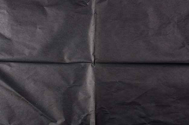 Черная бумага со складками. Текстура бумаги.