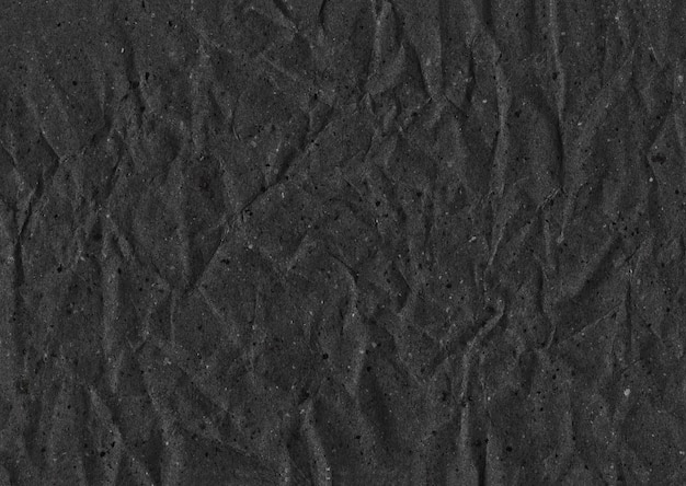 Black paper wrinkled texture background for design in your work concept