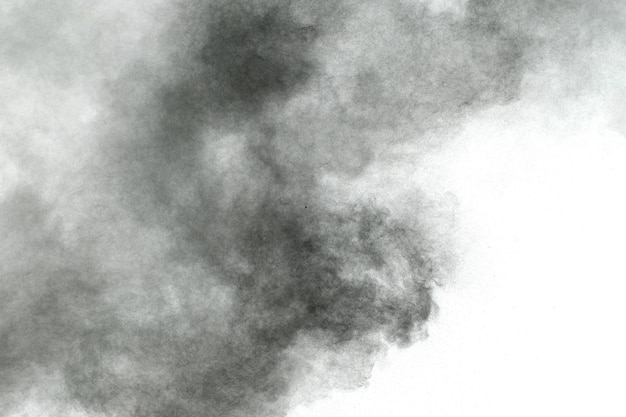Black particles splattered on white background Black powder dust splashing