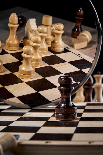 The black pawn looks in the mirror and sees a complete set of white pieces, the concept of strategy, planning and decision making, the concept of a leader for success