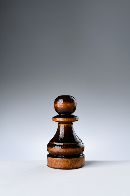 Black pawn on a white table