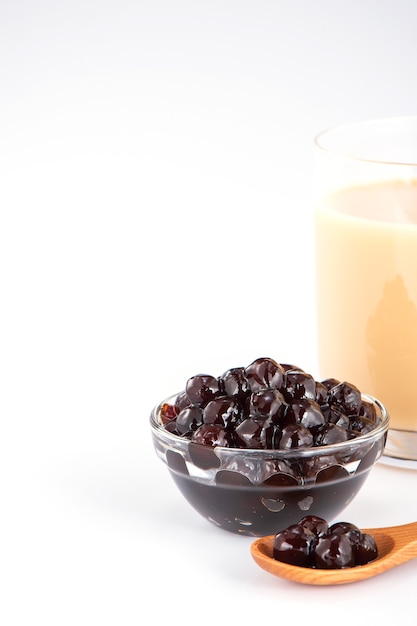 Black pearls. Boiled tapioca pearls for bubble tea on white background. Copy space