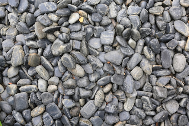 Black pebble stone on ground for texture background