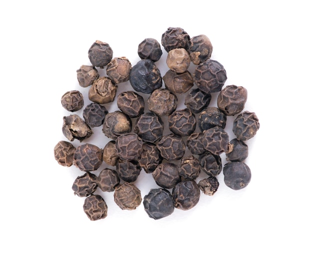 Black pepper grains isolated on white background