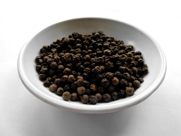 Black pepper isolated on a bowl