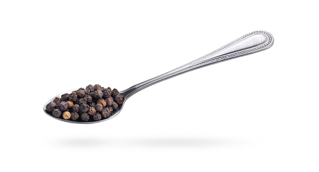 Black pepper in steel spoon isolated on a white background