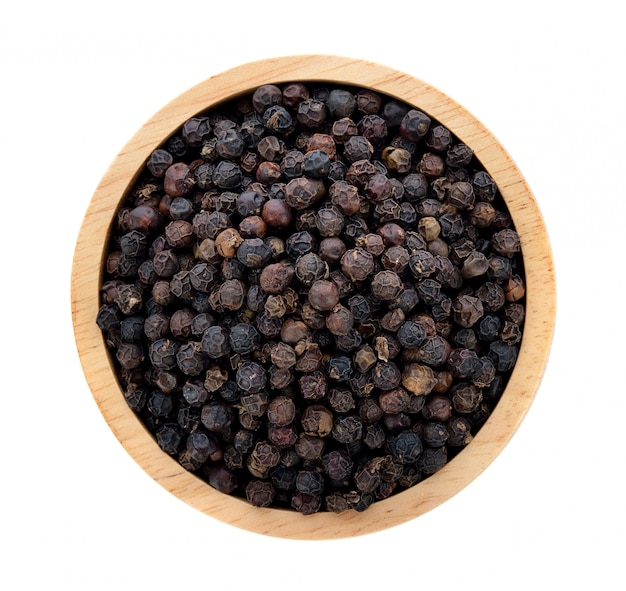 Black pepper in wooden bowl isolated on white background