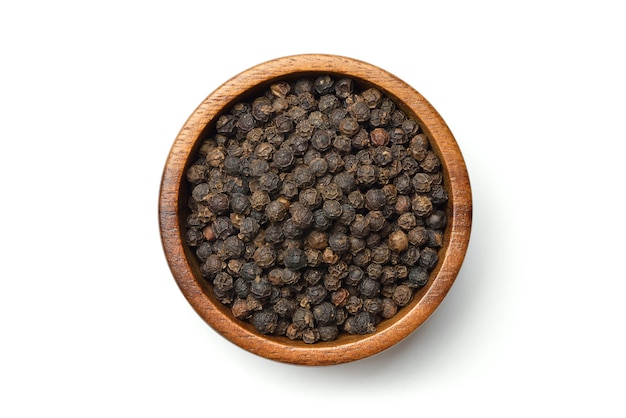 Black pepper on a wooden bowl