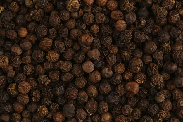 Black peppercorn close up. Macro texture of black hot pepper. Macro spice background.