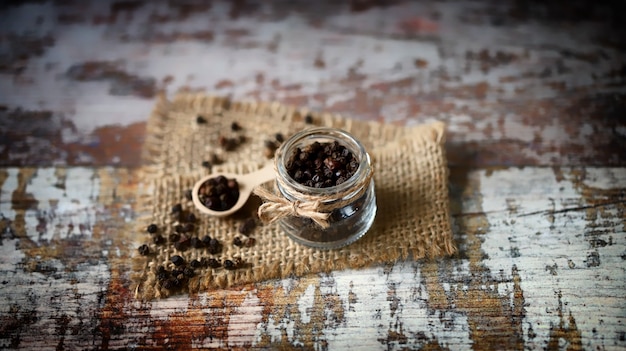 Black peppercorns in a jar.