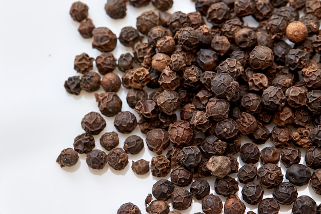 black peppers on white background