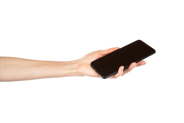 Black phone in female hand isolated on white background