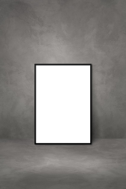 Black picture frame leaning on a dark concrete wall. Blank mockup template