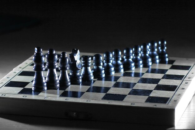 Photo black pieces on a chess board photo with copy space