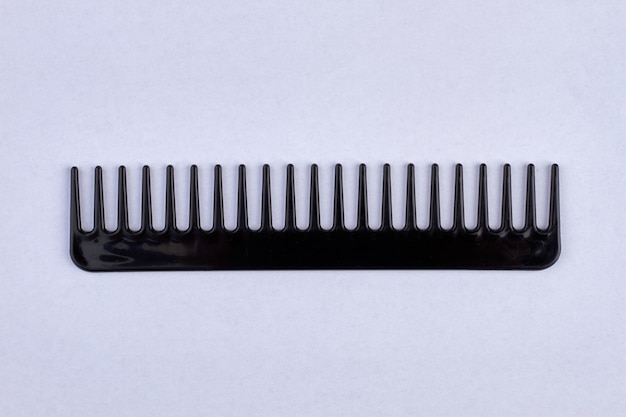 Black plastic comb. Isolated on white.