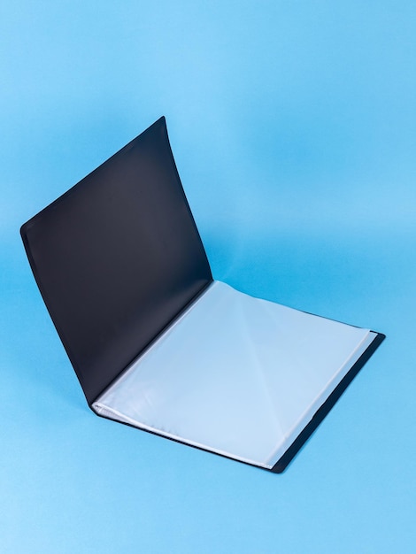 Premium Photo  Black plastic office folder on blue background office  folder template