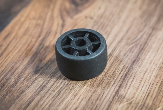 black plastic wheel which will attached to the furniture