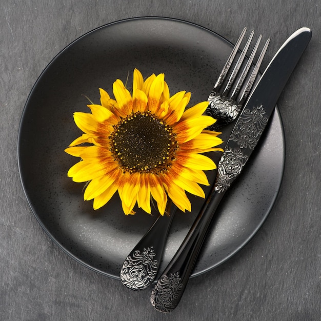 Black plate knife and fork black table setting from above