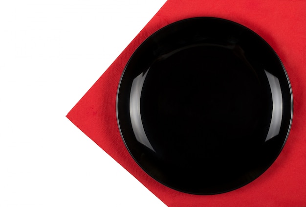 Black plate on a red napkin