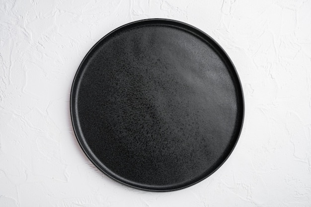 Black plate set, on white stone table background