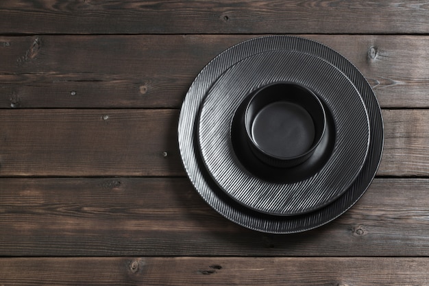 Photo black plates on wooden wall