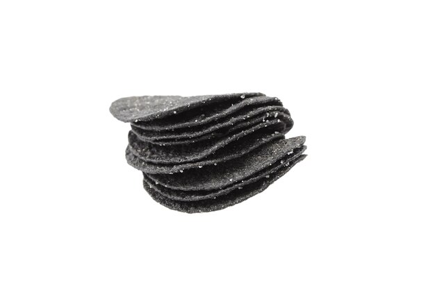 Black potato chips stack isolated on white