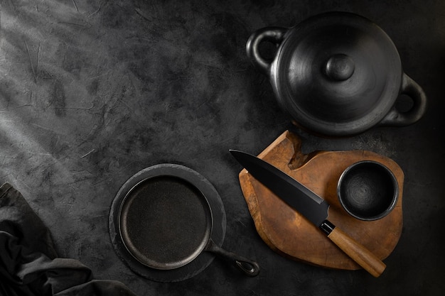 Black pots pans and kitchen utensils