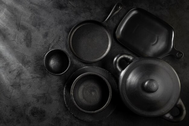 Black pots pans and kitchen utensils