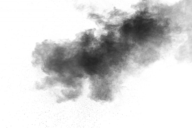 Black powder explosion on white background.Black dust particles splash.